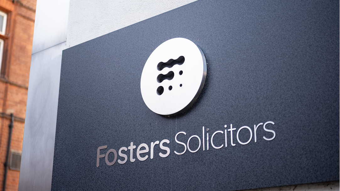 Fosters Solicitors wall-mounted sign at the office entrance