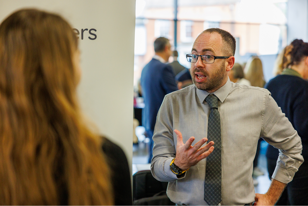 Fosters Solicitors representative speaking with attendees at a business networking event