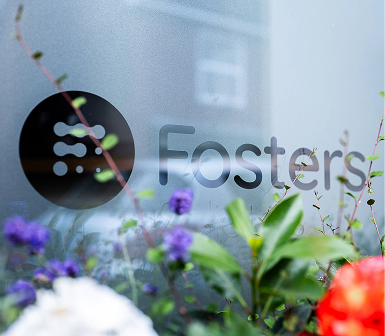 Fosters Solicitors window signage with flowers in the foreground