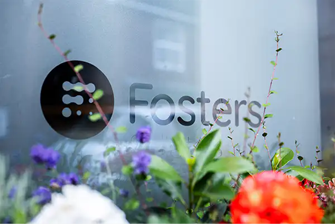 Fosters Solicitors window signage with flowers in the foreground