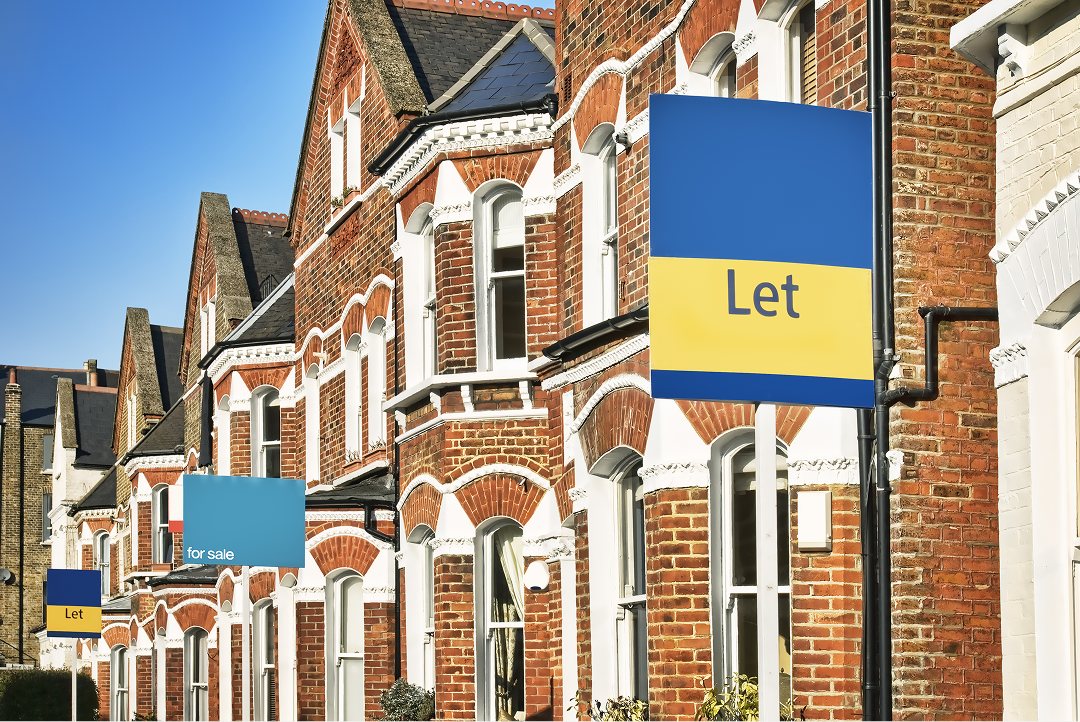 Row of terraced houses with Let and For Sale estate agent signs