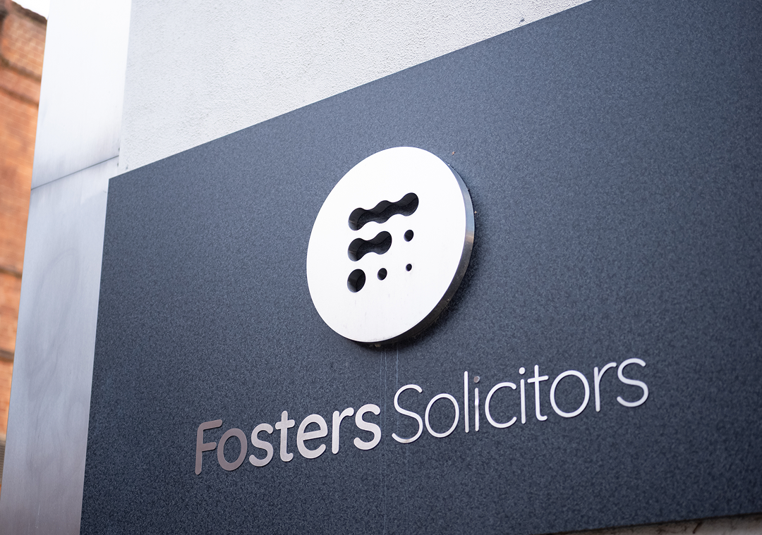 Fosters Solicitors wall-mounted sign at the office entrance