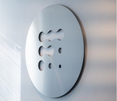 Decorative perforated metal panel on an office wall