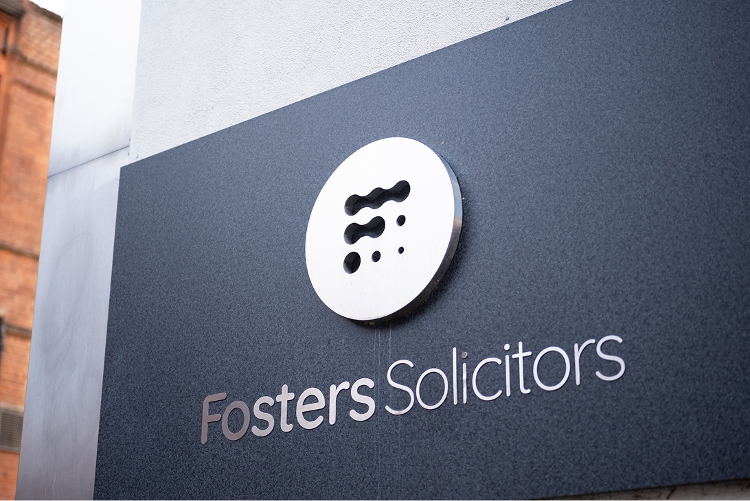 Fosters Solicitors wall-mounted sign at the office entrance