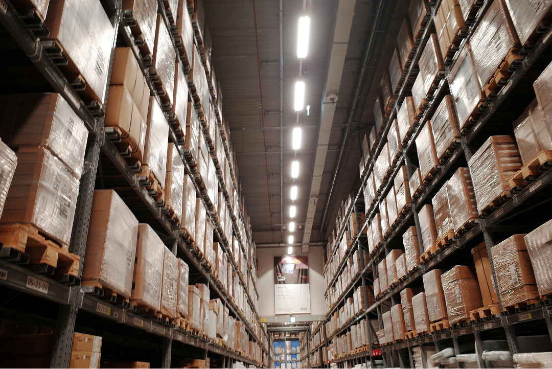 Interior of a warehouse with tall shelving stacked with boxes