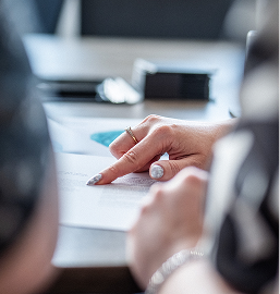 Close-up of hands reviewing legal documents at a desk