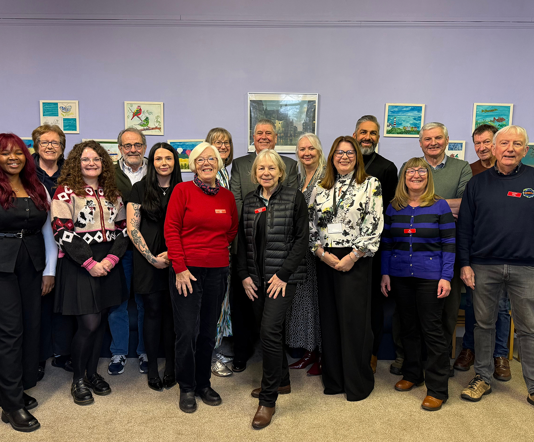 Fosters Solicitors team members posing with community group members at an indoor event